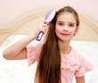 © svetamart - Portrait of cute smiling little girl child  brushing her hair