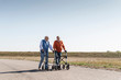 © Westend61 - Two old friends walking on a country road, using wheeled walkers