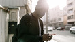 © Angel Ruiz Sanchez - Side view of young african american man in the city using his phone