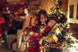 © luckybusiness - Happy holiday - females celebrating Christmas together.