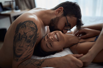 Tenderness in every touch. couple in bedroom..