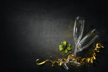 Wall Mural - Two champagne glasses with a horseshoe and shamrock as lucky charm