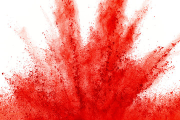 Wall Mural - Freeze motion of red powder exploding, isolated on white background. Abstract design of red dust cloud. Particles explosion screen saver, wallpaper