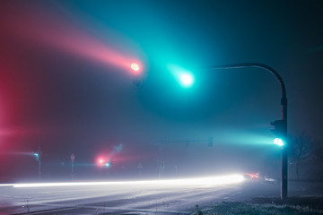 Traffic lights - crossroad in the foggy night