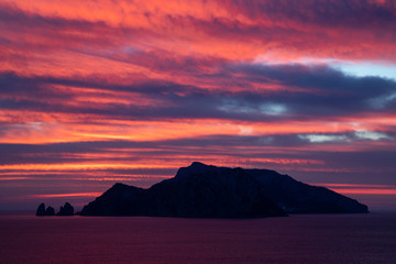 silhouette of Capri at sunset seen from Punta Campanela,  Sorrento Peninsula, Italy