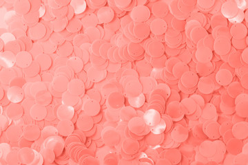 Wall Mural - Trend photography on the theme of the actual colors for this season - a shade of orange.  Large shiny semi-matt pink sequins fully filling the background space.