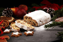 Traditional European Christmas Pastry, Fragrant Home Baked Stollen, With Spices And Dried Fruit. Sliced On Rustic Table With Xmas Tree Branches And Decorations