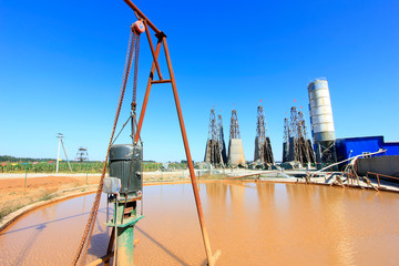 Wall Mural - Drilling rig derrick and yellow water in MaCheng iron mine, China