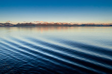 Ship Bow Wave Ripple Port Side And Dawn Lit Mountains In Background. Alaska, USA