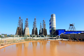 Wall Mural - Drilling rig derrick and yellow water in MaCheng iron mine, China