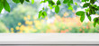 Empty white marble table over blur green nature park background, product display montage