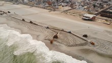 Aerial Shot Of Major Dredging Operation As Workers And Heavy Machinery Reconstruct The Beach On The Jersey Shore.