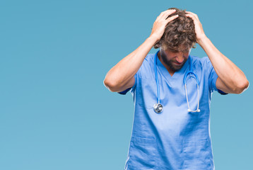 Poster - Handsome hispanic surgeon doctor man over isolated background suffering from headache desperate and stressed because pain and migraine. Hands on head.