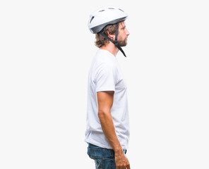 Sticker - Handsome hispanic cyclist man wearing safety helmet over isolated background looking to side, relax profile pose with natural face with confident smile.