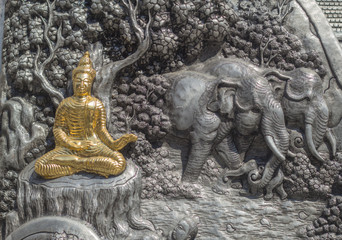 Wall Mural - Thai style silver carving art on temple wall , Wat Srisuphan ,Chiang Mai, Thailand.