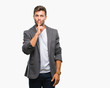 © Krakenimages.com - Young handsome business man over isolated background asking to be quiet with finger on lips. Silence and secret concept.