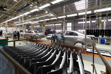 Workers assemble a vehicle body. process of welding cars. Modern Assembly of cars at the plant. automated build process of the car body