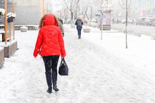 Winter, City, December, It Is Snowing, A Woman In A Red Jacket Walking Down The Street, Rear View