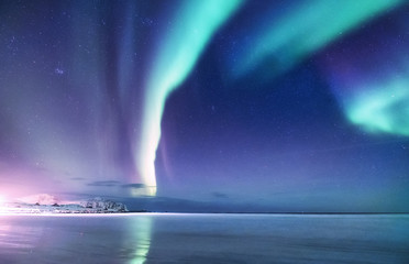 aurora borealis on the lofoten islands, norway. green northern lights above mountains. night sky wit