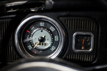 Wall Mural - Old car dashboard and instrument claster on dark interior	