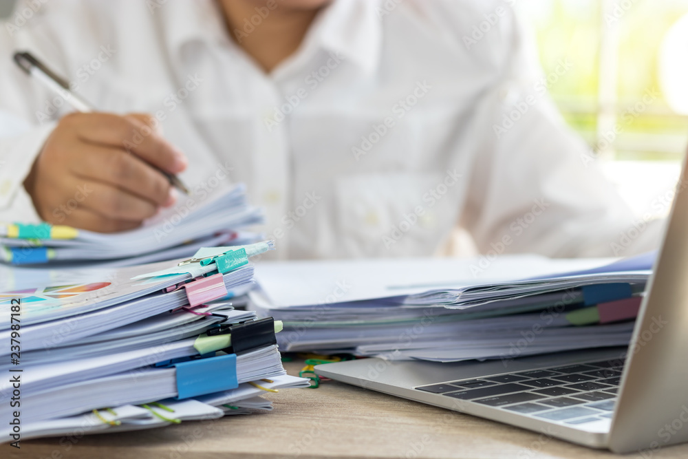 Teacher holding pen by hand for checking student homework assignments ...