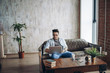 Bearded Hipster working Laptop modern Interior Design Loft Office.Man work Retro Sofa,Use contemporary Notebook,typing message.Blurred Background.Creative Business Startup Idea.Horizontal,Film