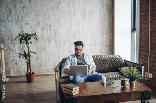 Bearded Hipster Working Laptop Modern Interior Design Loft Office Man Work Retro Sofa Use Contemporary Notebook Typing Message Blurred Background Creative Business Startup Idea Horizontal Film Buy This Stock Photo And Explore Similar Images At Adobe