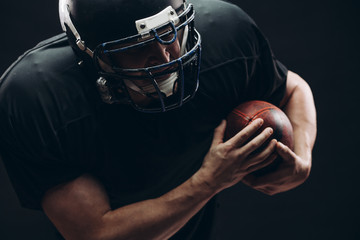 Wall Mural - American football player with helmet and armour in the decisive game takes responsibility of the results of the game .