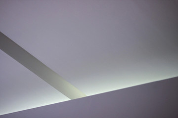 Poster - Refined abstract architecture or interior design photo of plastered ceiling with recessed lighting. Minimalist geometric background with angular structure and copyspace for text placement.