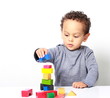 © herlanzer - little boy testing his creativity by building towers with toy building blocks stock photo