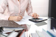 © rogerphoto - Bookkeeper woman or financial inspector  making report, calculating or checking balance, close-up. Business portrait. Copy space area for audit or tax concepts
