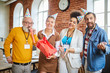 © pressmaster - Joyful colleagues in birthday caps looking at you while having fun together in office
