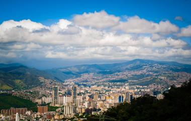 Wall Mural - above view of Caracas city in Venezuela from Avila mountain during sunny cloudy summer day