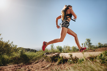 female runner sprinting outdoors