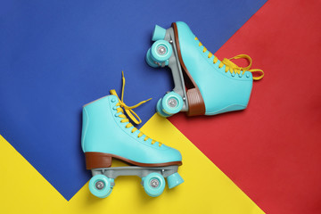 Wall Mural - Pair of stylish quad roller skates on color background, top view