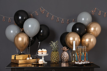 Sticker - Party treats and items on table in room decorated with balloons