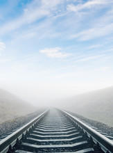 Railroad In Fog To Horizon In Clouds