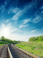 Wall Mural - sunset in blue sky with clouds over railway to horizon