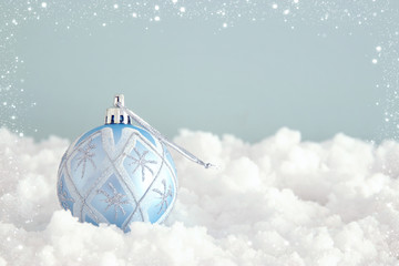 Image of christmas festive tree blue ball decoration in front of pastel background background.