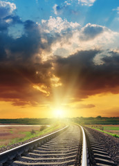 Wall Mural - bright orange sunset over railroad closeup