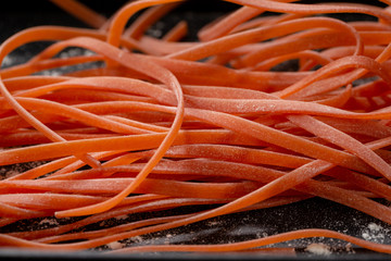 Red pasta close-up on black