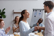 Excited mixed race girl employee get promotion feels happy handshaking with executive manager or company boss. Director greeting newcomer or congratulating successful worker with high rates at work