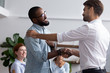 Diverse people gathered in meeting executive manager shake hands with black employee impressed by professionalism for leadership qualities creative solutions and efforts rewarding him for amazing work