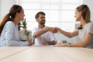 Wall Mural - diverse business partners client and boss handshaking greeting each other at business meeting or con