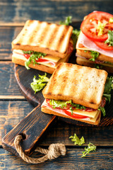 Wall Mural - sandwiches with grilled toast ham salami cheese tomatoes and lettuce