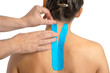 © tutye - Female back with physio tape on white background