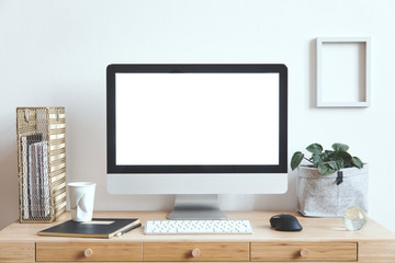 Wall Mural - White scandinavian interior of home creative desk with mock up computer screen, blank photo frame, plant, office accessories and gold organizer. Minimalistic space for work, hobby and listen music. 