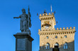 Statue of Liberty against the background of the Public Palace (Palazzo Pubblico). Is the town hall of the city, as well as its official Government Building . San Marino, Italy.