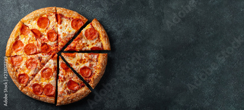 Fotomural Tasty pepperoni pizza and cooking ingredients tomatoes basil on black concrete background