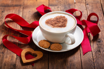 Valentines day. Cup of cappuccino coffee with heart on foam